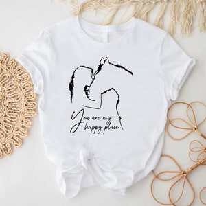 a white t - shirt with a picture of a horse and the words you are