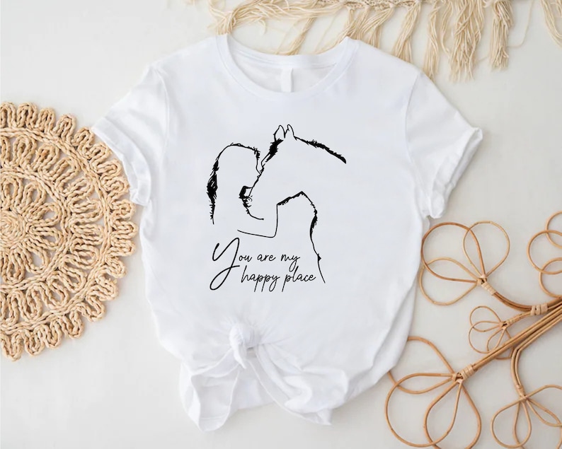 a white t - shirt with a picture of a horse and the words you are