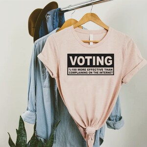 a t - shirt that says voting on it hanging on a rack