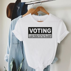 a t - shirt that says voting on it hanging on a clothes rack