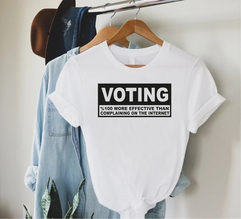 a t - shirt that says voting on it hanging on a clothes rack