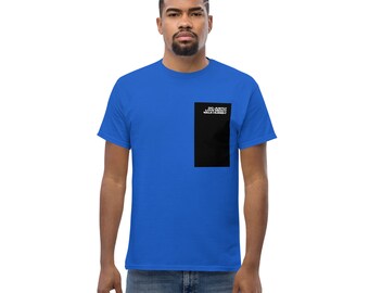 May include: A royal blue t-shirt with a black square on the right side of the chest. The square has white text that reads "DO EVERY LITTLE THING WITH HUMILITY".