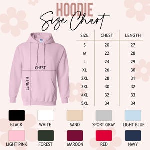 May include: A light pink hoodie with a size chart. The chart lists chest measurements from 20 to 34 inches and lengths from 27 to 34 inches. Available colors include black, white, sand, sport gray, light blue, light pink, forest, maroon, red, and navy.