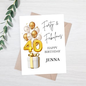 May include: A white birthday card with the text "Forty & Fabulous" and "Happy Birthday Jenna". The card features a gold number 40 balloon, gold and white balloons, and a gift box with a gold bow.