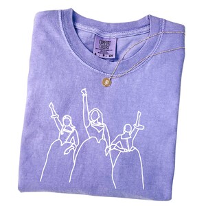 a t - shirt with a picture of a group of people on it