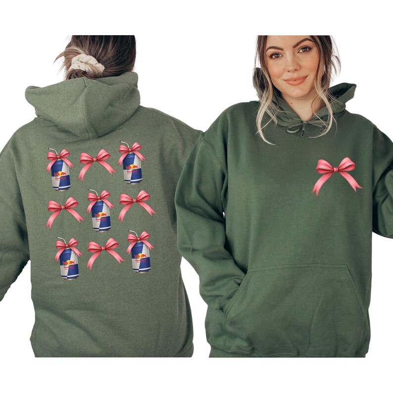 a woman wearing a green hoodie with pink bows on the back.