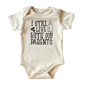 I Still Live with My Parents Baby Bodysuit • Hilarious Baby Onesies® • Natural Color Baby Clothing • Gift for New Parents • Printed in USA