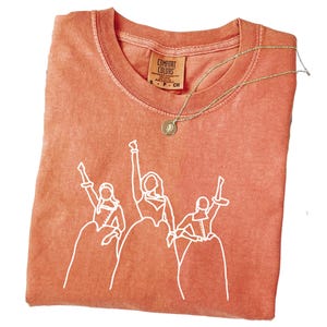 a t - shirt with a picture of a group of people on it