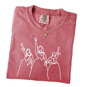 a t - shirt with a picture of a group of people on it