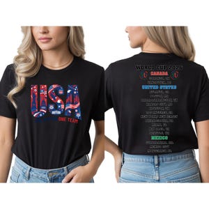a woman wearing a black t-shirt with a graphic design on the front and text on the back.