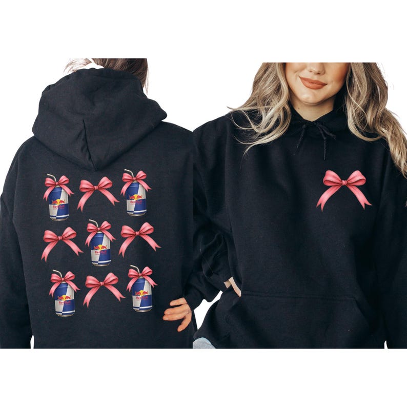 two women wearing black hooded sweatshirts with pink bows on the back.