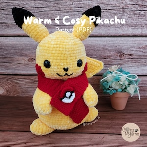 May include: A handmade yellow Pikachu plushie with black ears and a red scarf featuring a white and black design. The text "Warm & Cozy Pikachu Pattern (PDF)" is visible. The plushie is on a wooden surface.