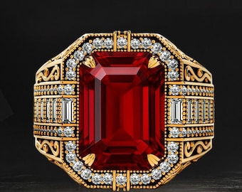 May include: A gold-toned ring with a large, rectangular, deep red gemstone as the centerpiece. The ring is adorned with small, clear gemstones and intricate filigree detailing. The design is symmetrical and ornate, with a classic, luxurious aesthetic.