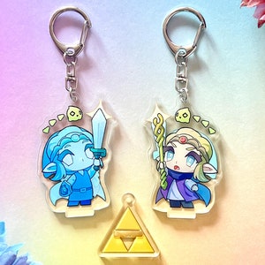 Princesse Zelda : Echoes of Wisdom - Porte-clés avec breloques en acrylique et voyageur debout ft. Tri (The Legend of Zelda EOW)
