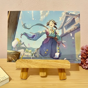 May include: A colorful illustration of a person in a blue, purple, and green outfit with long flowing hair, standing in front of a Japanese-style building. The person is smiling and holding a sword. The background is a light blue sky with white clouds and pink flowers.