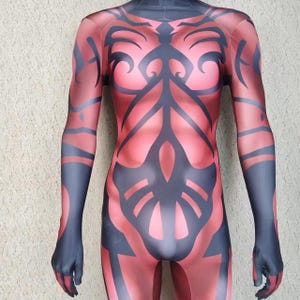 May include: A red and black bodysuit with a tribal design. The bodysuit is made of a stretchy material and has long sleeves.