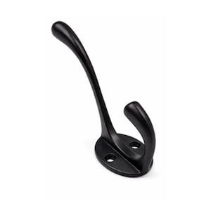 May include: A matte black metal wall hook featuring a dual-prong design with one long, curved upper arm and one shorter, lower hook. The base is oval-shaped and includes two pre-drilled circular holes for mounting screws to secure it to a flat surface.