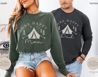 May include: Two long-sleeved shirts, one dark green and one charcoal gray, each with a camping-themed graphic. The dark green shirt says "One Happy Mom" and the charcoal gray shirt says "One Happy Dad". Both shirts have a tent, trees, moon, and stars.