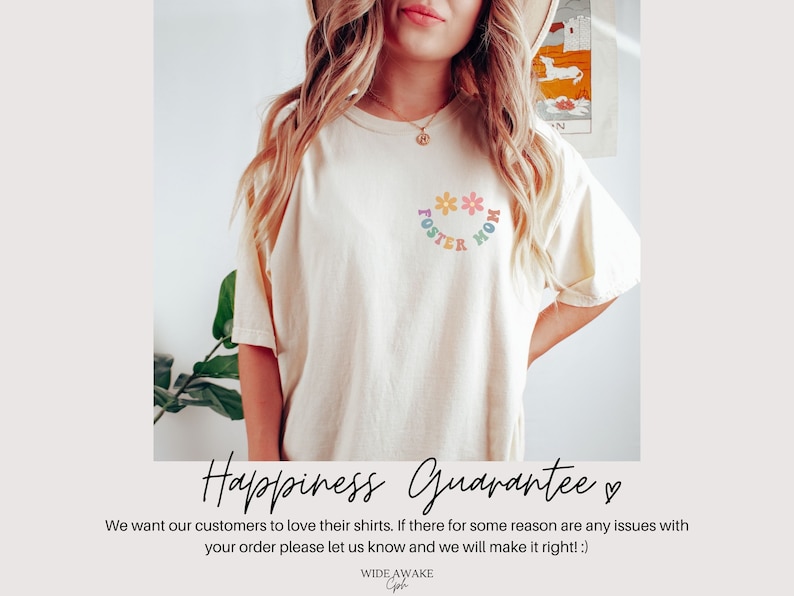 May include: A white t-shirt with a rainbow graphic that says "Foster Mom" with flowers around the text. The text "Happiness Guarantee" is written in black cursive with a heart symbol.