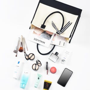 the contents of a purse are laid out on a white surface
