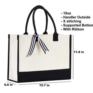a white and black bag with a bow on it