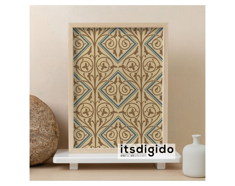 May include: A framed print of a beige and blue geometric pattern with a repeating design of stylized leaves and diamonds. The frame is a light wood color. The print is on a white shelf with a round stone and a white vase.