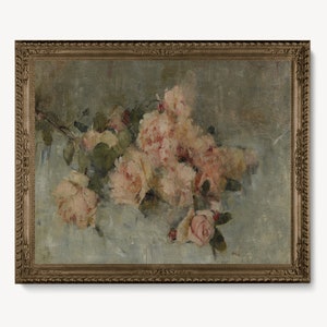 May include: A framed oil painting of a bouquet of pink roses on a light blue background. The roses are arranged in a loose, natural style, with some of the petals falling onto the surface below. The painting is framed in a simple, gold-colored frame.