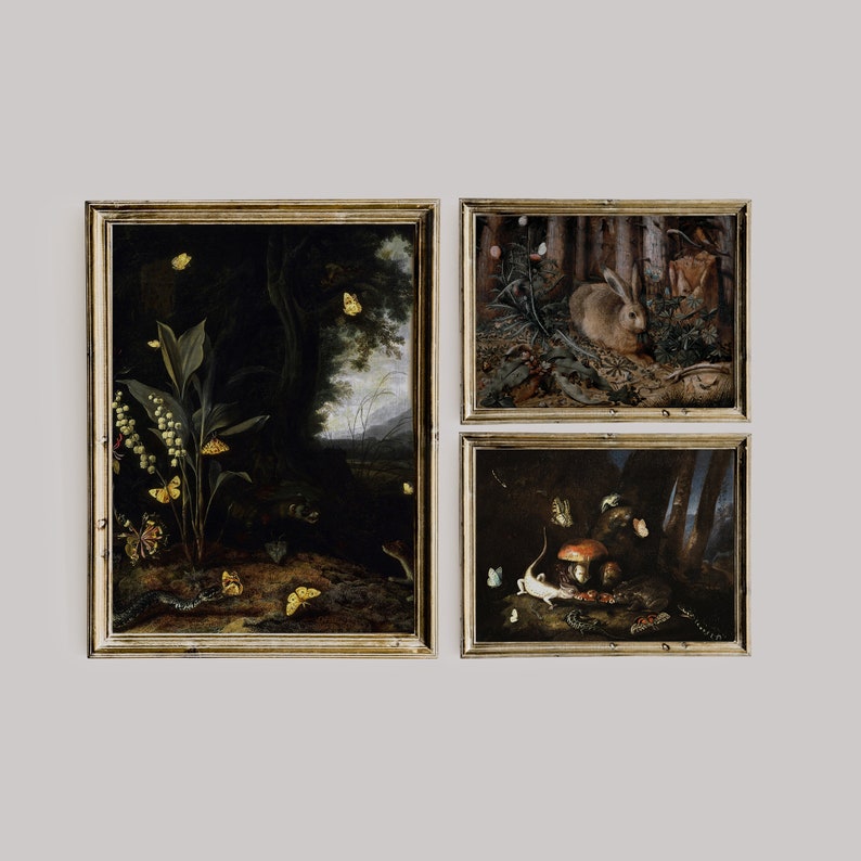 May include: Three framed paintings with dark backgrounds and gold frames. The first painting depicts a forest scene with a variety of butterflies and a plant with white flowers. The second painting shows a rabbit in a forest setting. The third painting features a mushroom and a lizard in a dark forest.
