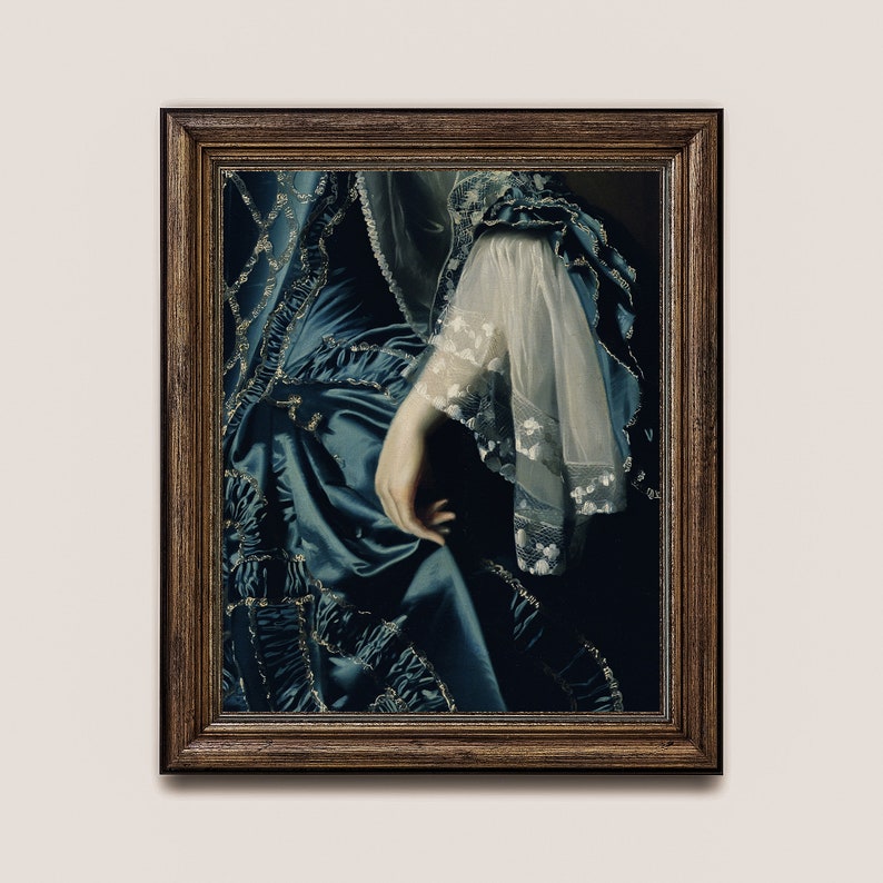 May include: A framed painting of a woman wearing a blue and gold dress with a white lace sleeve. The woman's hand is visible, resting on the dress.