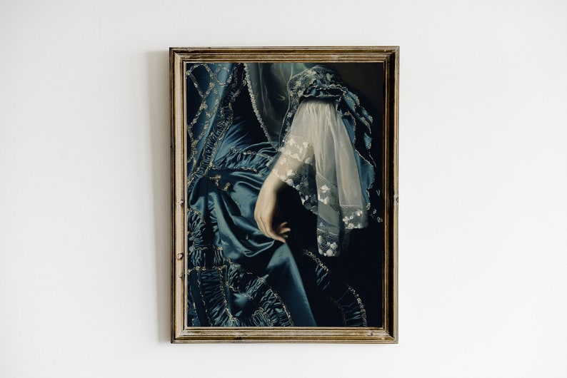 May include: A framed painting of a woman wearing a blue dress with lace detailing. The woman's hand is visible, resting on the dress.