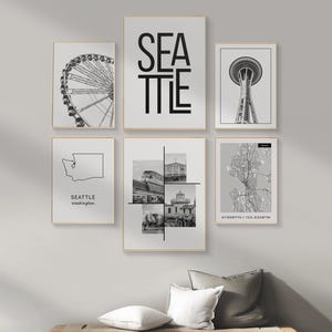 May include: A set of six black and white prints featuring various images of Seattle, Washington. The prints include a Ferris wheel, the Space Needle, a map of the city, and a collage of different landmarks. The word "SEATTLE" is displayed in bold, black letters on a white background.