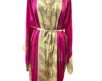 May include: A pink and yellow silk robe with a floral pattern. The robe has a tie belt and long sleeves.