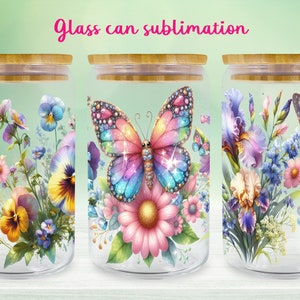 Puede incluir: Tres tarros de vidrio con tapas de bambú, cada uno con un diseño floral diferente con mariposas. Los diseños incluyen pensamientos, iris y una gran margarita rosa con una mariposa en el centro.