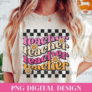 May include: A white t-shirt with a checkered pattern and the word "teacher" repeated four times in pink, orange, and yellow with a smiley face flower graphic.