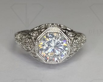 May include: A silver ring with an octagon-shaped diamond set in a filigree design.