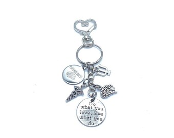 May include: Silver keychain with a variety of charms, including a brain, a caduceus, a psychology symbol, and a round charm with the text "Do what you love, love what you do".