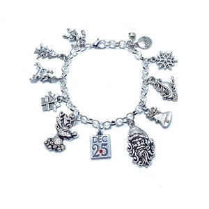 May include: A silver charm bracelet with a variety of Christmas-themed charms, including a reindeer, a snowflake, a Santa Claus, a bell, a tree, a gift box, a sleigh, and a charm that says "Believe".