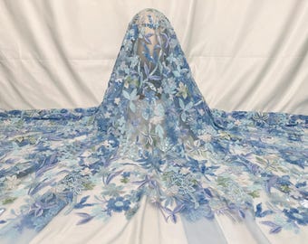 May include: Light blue floral lace fabric with sequins. The fabric features a delicate floral pattern with sequins scattered throughout.