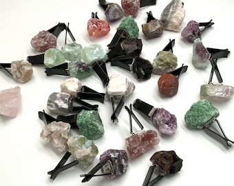 May include: A collection of various colored crystal car air fresheners. Each crystal is attached to a black metal clip.