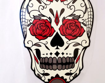 May include: White sugar skull with red roses and black floral designs. The skull has a black spade in the center of the forehead.