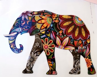 May include: A colorful, patterned elephant silhouette with intricate floral designs in shades of red, yellow, blue, green, and pink. The elephant is facing left and has a raised trunk.