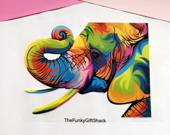 May include: A colorful abstract painting of an elephant's head with a bright yellow, orange, red, blue, green, and purple color scheme. The elephant's trunk is curled up and the image is cropped at the bottom.