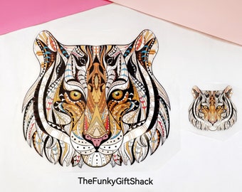 May include: A colorful, intricate design of a tiger's face with black, white, orange, and blue details. The design is on a white background. The text "TheFunkyGiftShack" is at the bottom of the image.