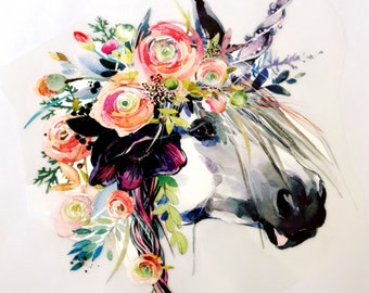 May include: Watercolor image of a white horse head adorned with a floral crown. The flowers are in shades of pink, orange, and purple, with green leaves. The horse has a gray mane and a black eye. The text "TheFunkyGiftShack" is at the bottom.