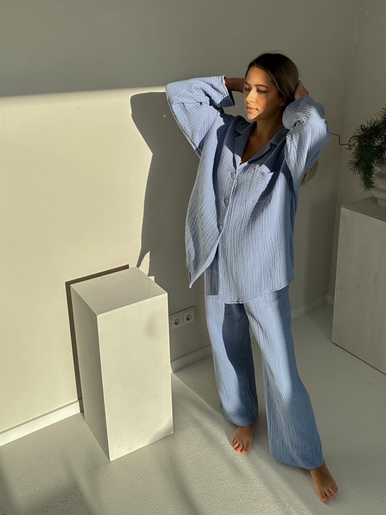 May include: A light blue pajama set with a button-up top and wide-leg pants. The fabric has a waffle texture.