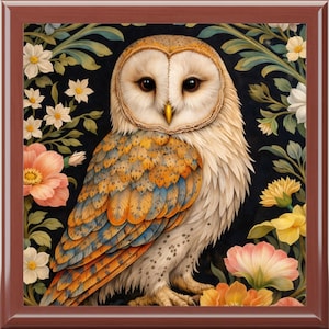 May include: A square wooden tray featuring a detailed illustration of a barn owl. The owl has white, orange, and blue feathers, set against a backdrop of dark green foliage and colorful flowers. The tray has a dark brown border.