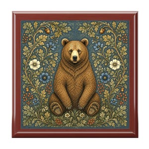 May include: A brown bear illustration sits centered on a square, framed by a dark red border. The bear is surrounded by a floral design with blue, white, and yellow flowers, and green foliage against a teal background.