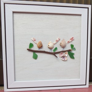 painting of birds perched on a tree branch made of seashells and beach glass