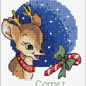 May include: A cross-stitch pattern of a cartoon reindeer with a red collar and a candy cane with a green bow. The reindeer is looking at the candy cane. The background is a blue circle with white snowflakes. The text "Comet" is written below the reindeer.