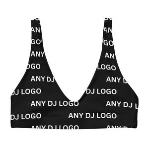 May include: Black bikini top with a V-neck design. The top is covered in a repeating pattern of the words "ANY DJ LOGO" in white. The top is a swimwear item.
